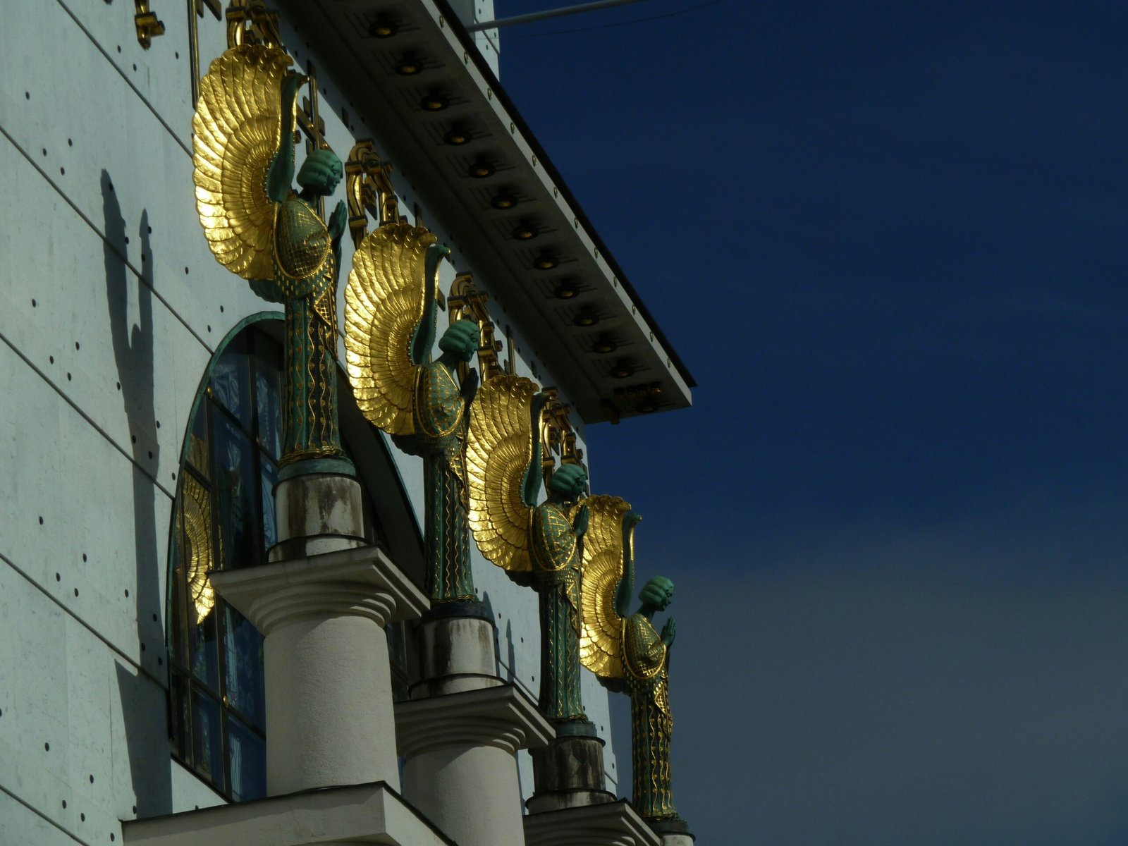 a building with gold decorations on the side of it